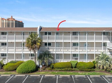 View of property featuring uncovered parking