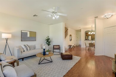 Living area featuring wood finished floors, a cha