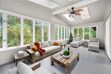 Relax and unwind in the upper-level sun room that flows directly from the living/dining area. Is there anything more calming than being surrounded by nature?