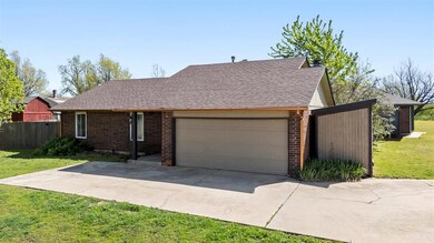 View of front of home featuring a garage, fence, b