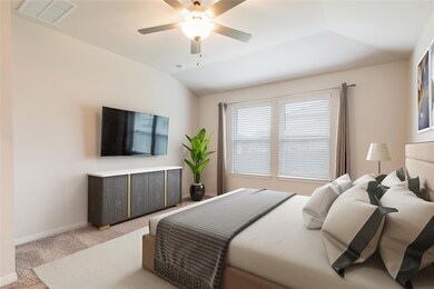 Bedroom with visible vents, lofted ceiling, baseb