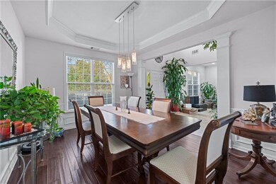 Dining area with a tray ceiling, visible vents, or