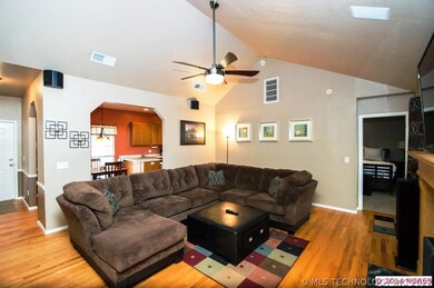 Hardwood floors and a vaulted ceiling are warm and