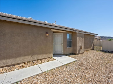 View of exterior entry with stucco siding and a ga