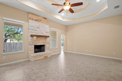 Unfurnished living room with a tray ceiling, orna