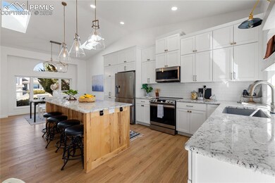 Kitchen featuring light wood-style flooring, stain