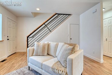 Living room with light hardwood / wood-style floor