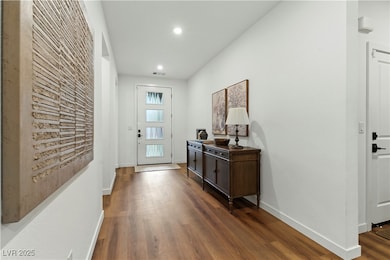 Entryway with dark wood-style floors and recessed lighting