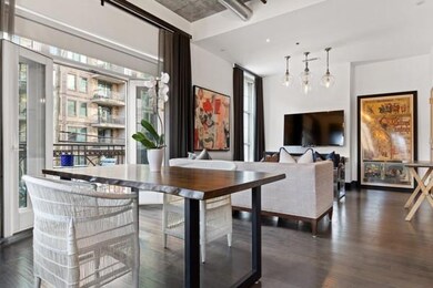 Dining space with a wealth of natural light and dark wood-type flooring