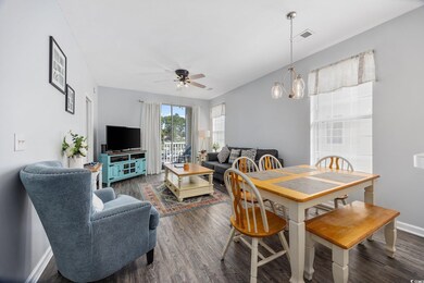 Dining space with ceiling fan with notable chandel