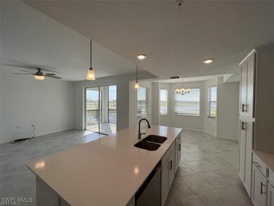 Kitchen with a sink, plenty of natural light, a ch