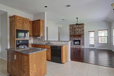 Kitchen featuring tasteful backsplash, black appli