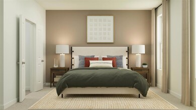 Bedroom featuring carpet flooring and baseboards