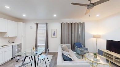 Living area with light wood finished floors, recessed lighting, and ceiling fan