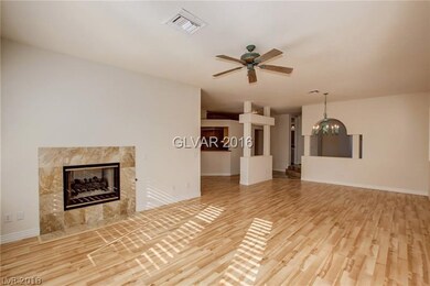 Living room w/ 2-way Fireplace, wood flooring