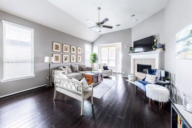 The gorgeous and durable flooring is highlighted in this view of the family room with waves of sunlight from all the windows. There's plenty of space for all of your furniture. What a lovely and cheerful space to spend time in with your family and friends!