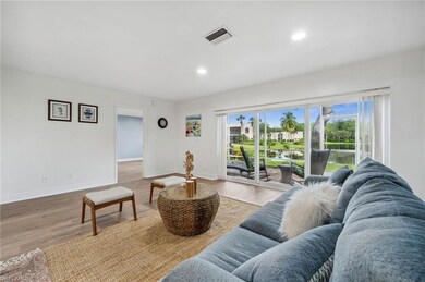 Living room with light hardwood / wood-style floor