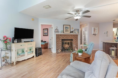 Living area featuring a textured ceiling, a brick 