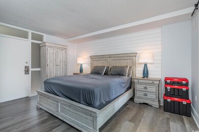 Bedroom with a textured ceiling and wood finished 