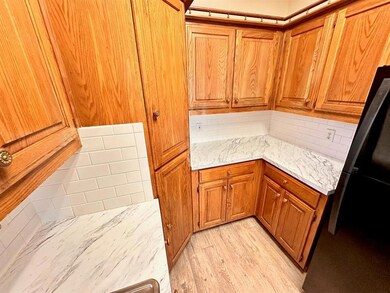 Kitchen with brown cabinets, freestanding refrige