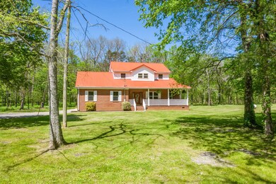 Loaded with curb appeal you are going to LOVE including an oversized, L-shaped wrap around porch, metal roof, mostly brick construction and tons of windows/natural light!