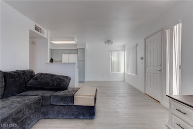 Living room with light wood-style floors and baseb