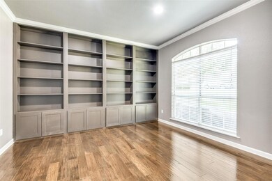 Spare room featuring plenty of natural light, hardwood / wood-style flooring, and ornamental molding