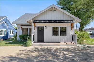 View of front of property featuring board and batten siding, a standing seam roof, and a metal roof
