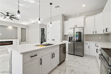 Kitchen featuring visible vents, marble finish flo