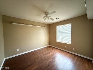 Unfurnished room with a ceiling fan, baseboards, a