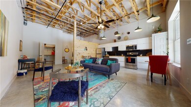Living room with ceiling fan, baseboards, a toweri