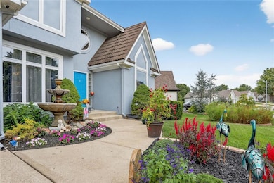 View of front sidewalk lined with landscaping
