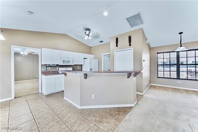 Kitchen featuring white appliances, visible vents,