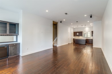 This stunning living and dining area combo isn’t your typical open concept, it’s better. Thoughtfully defined yet seamlessly connected, it offers the perfect balance of intimacy and flow. From the kitchen, enjoy direct sightlines into both spaces, making entertaining effortless and everyday moments more connected. The space is a showstopper: 11-foot ceilings soar overhead, amplifying light and luxury, while gleaming hardwood floors ground the space in timeless beauty. Nestled within is a built-in entertainment nook complete with a wine bar, ideal for movie nights, game days, or quiet evenings with your favorite pour and playlist, all enhanced by surround sound. Style, comfort, and functionality fill every corner. This is more than a space, it’s where life unfolds beautifully.