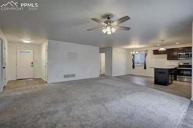 Unfurnished living room featuring carpet flooring 