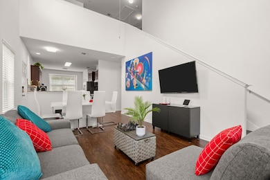 Living area featuring attic access and wood finis