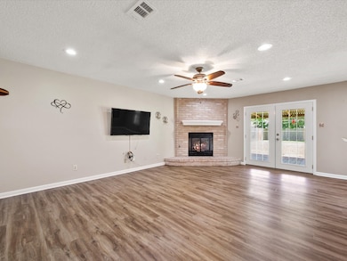 Open Family Room with fireplace and upgraded vinyl