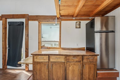 Kitchen with freestanding refrigerator, brown cab