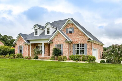 Home sits on corner lot with beautiful landscaping and concrete driveway.