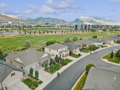 Aerial view of residential area with mountains and a golf course