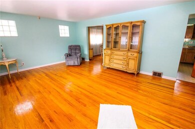 Spacious living room leading to kitchen and dining