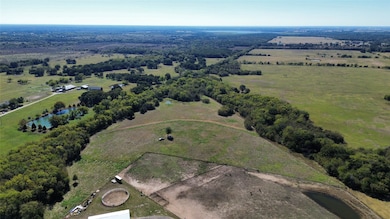 Aerial overview of property's location with a nearby body of water and rural landscape