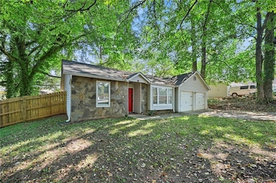 View of front of house featuring a garage, stone s