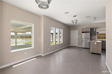 Unfurnished living room featuring sink, light tile patterned flooring, and a chandelier