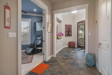 Just inside, the dedicated office sits to the right, positioned close to the entry but still separate from the main gathering areas