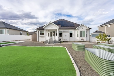 Back of property featuring a fenced backyard, solar panels, and a patio area