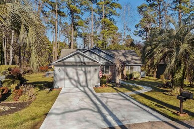 Ranch-style home with a garage and a front lawn