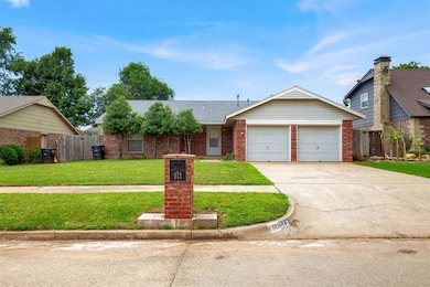 View of front of home with a garage and a front ya