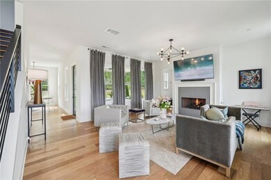 Living area with a chandelier, light wood-style fl