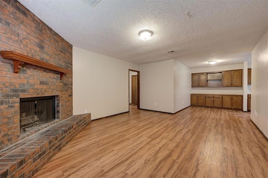 Unfurnished living room featuring light hardwood /